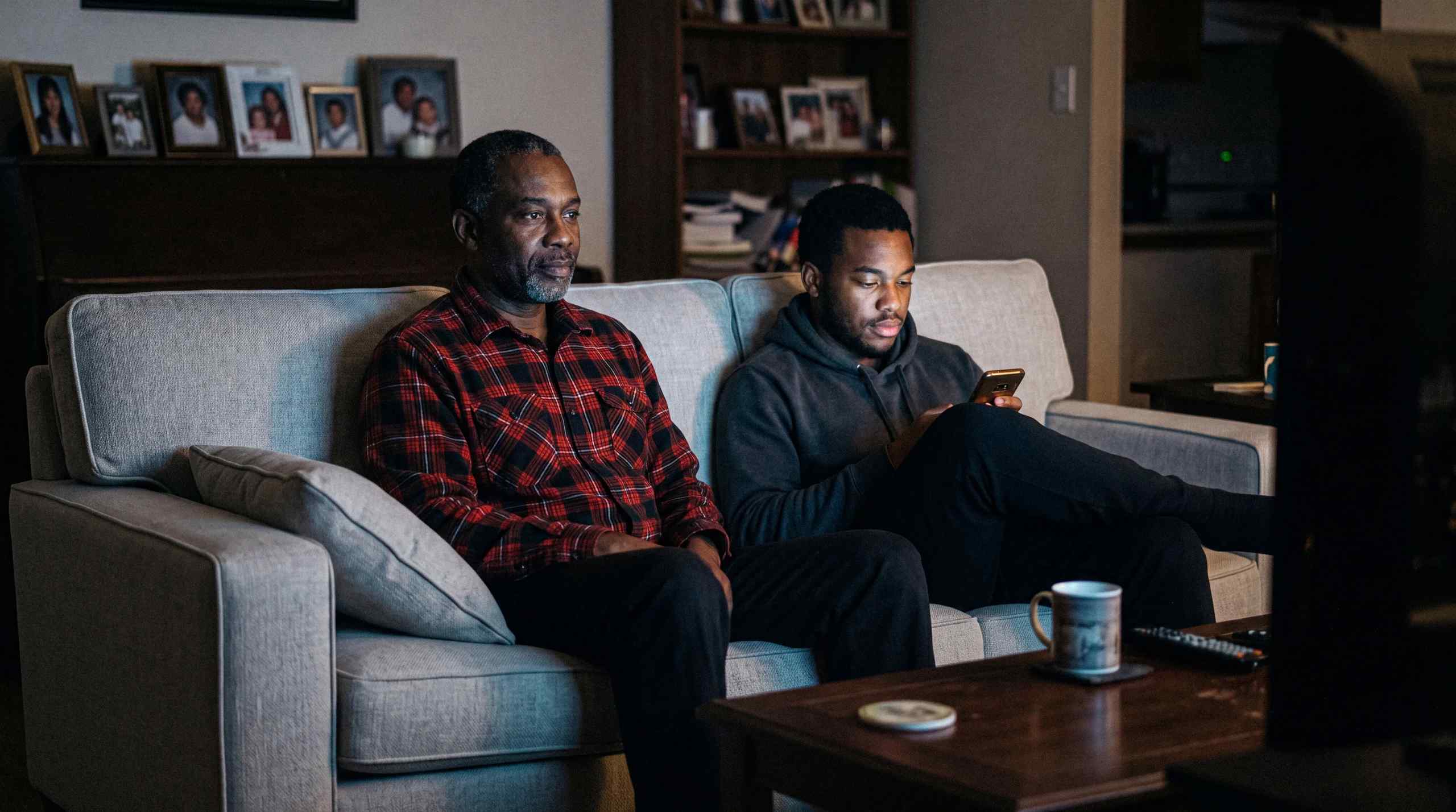 Two men watching sports at home.